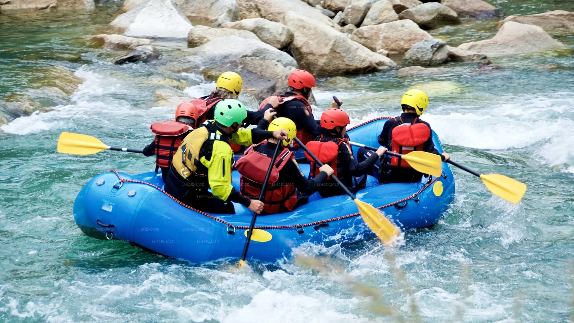 Group of people rafting on a river with rocks and water rapids.