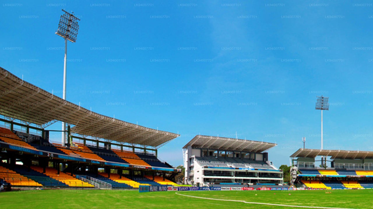 Stadium with green field and blue sky
